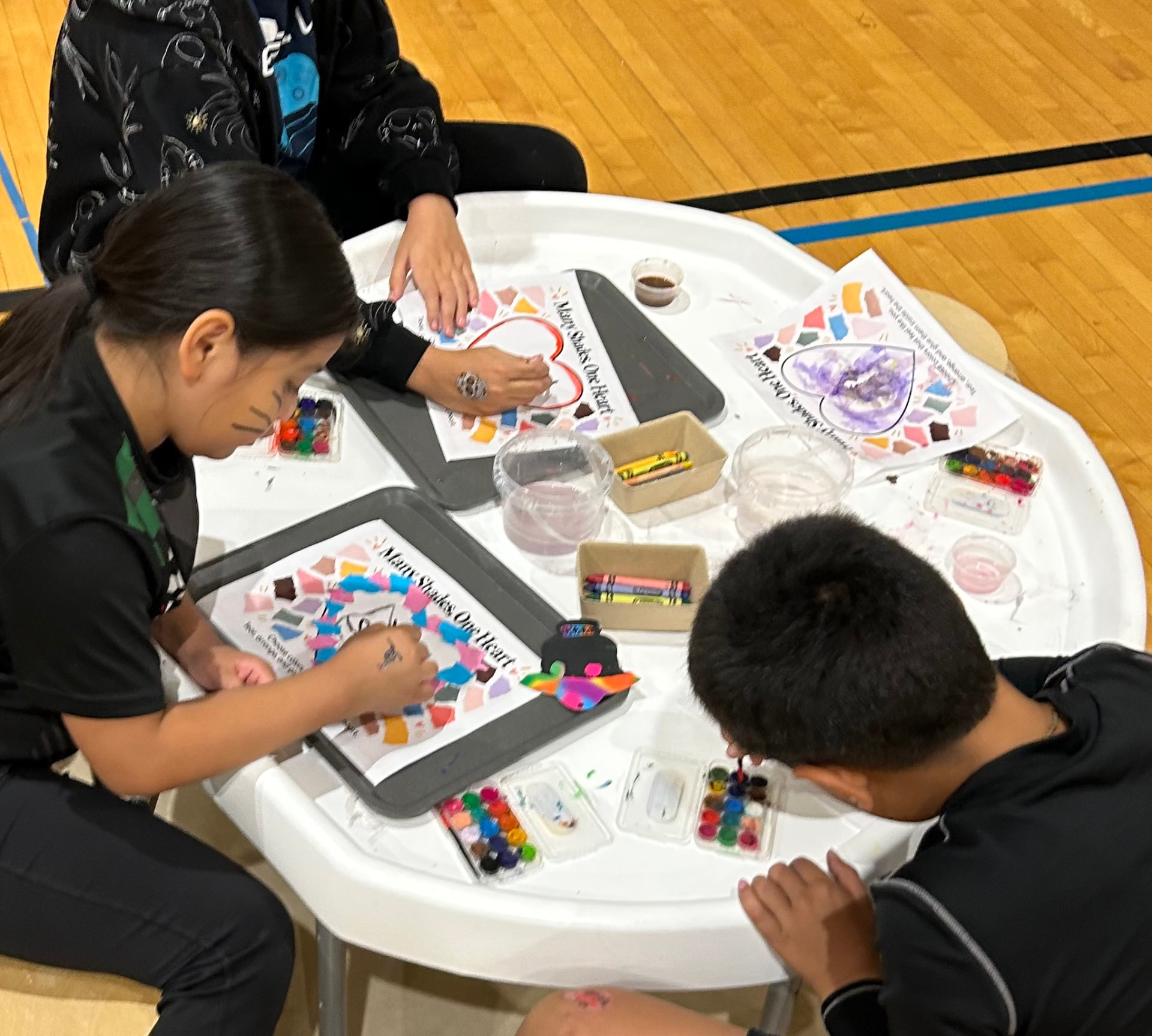 Children painting and creating around a large white Meka Tuff Tray